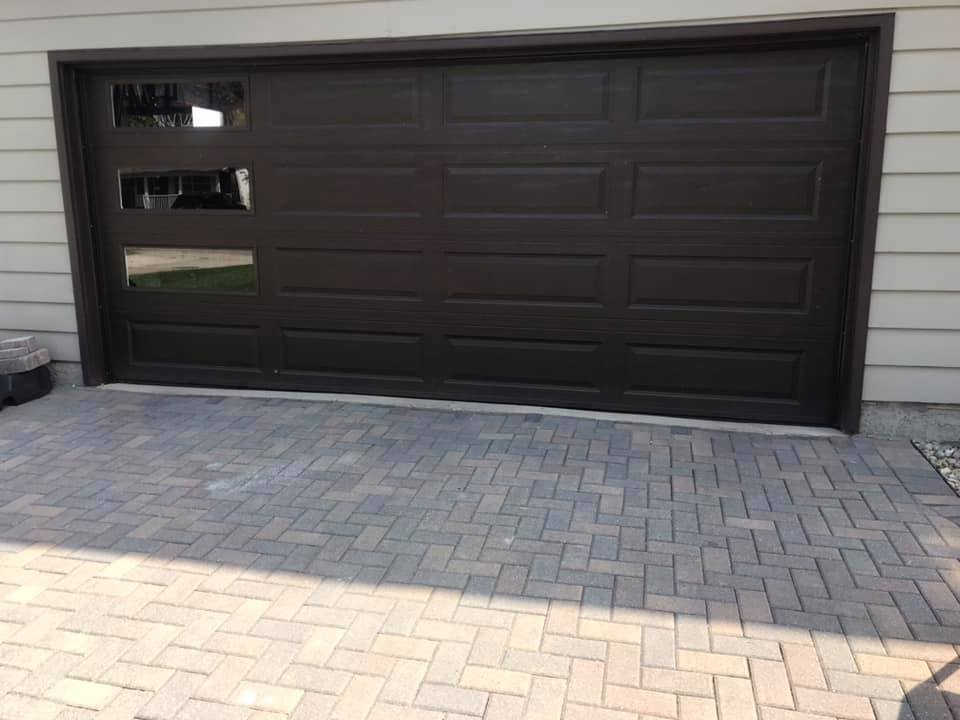 Beautiful new dark brown garage door with windows
