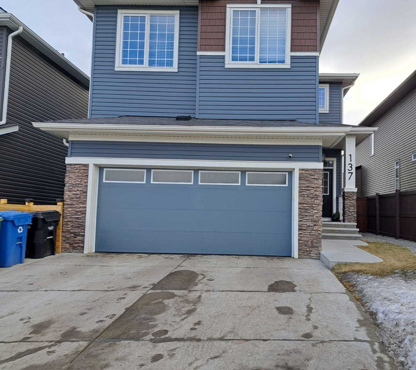 Beautiful new blue garage door with windows