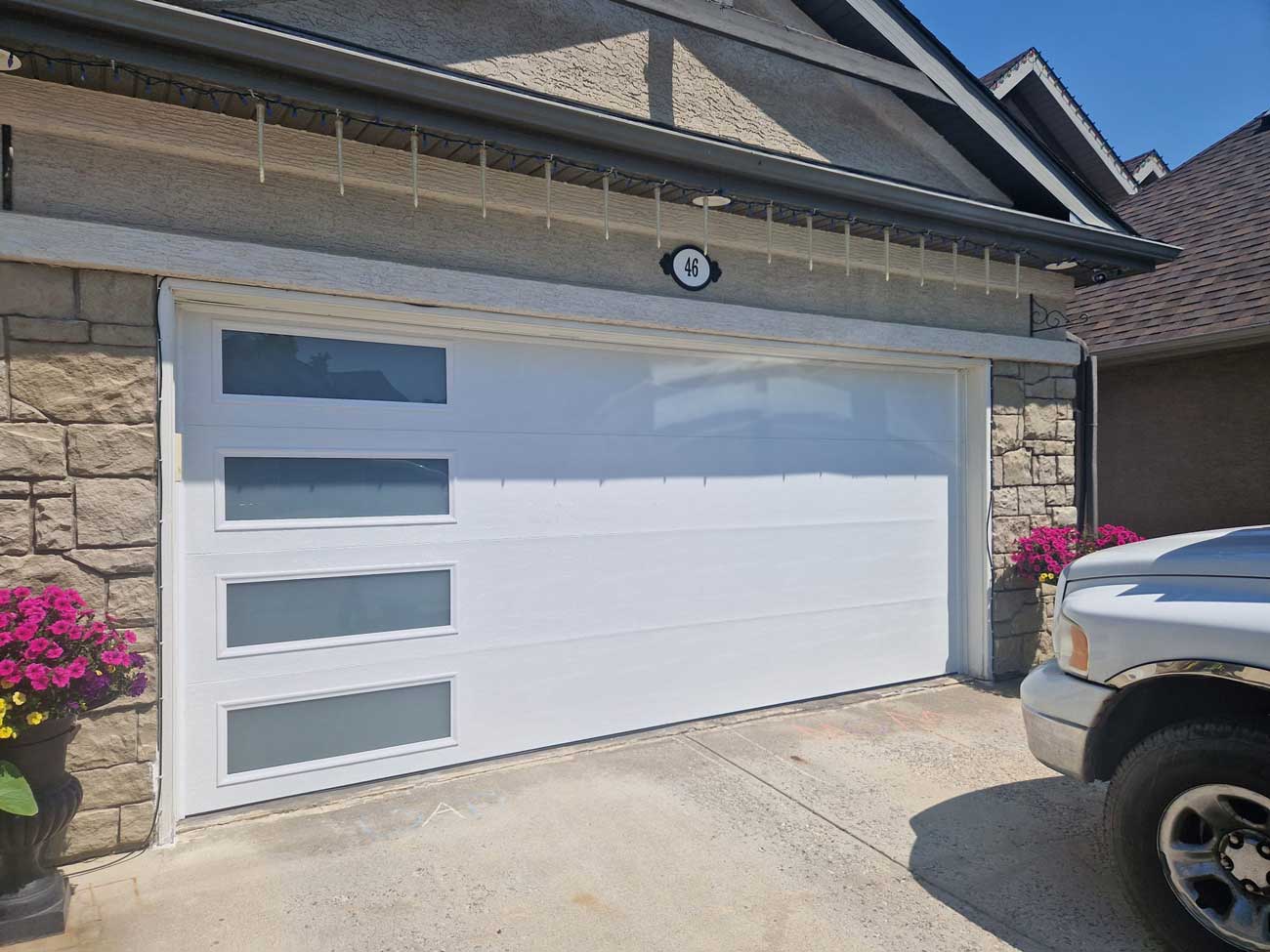 Beautiful new white garage door with mosaic windows