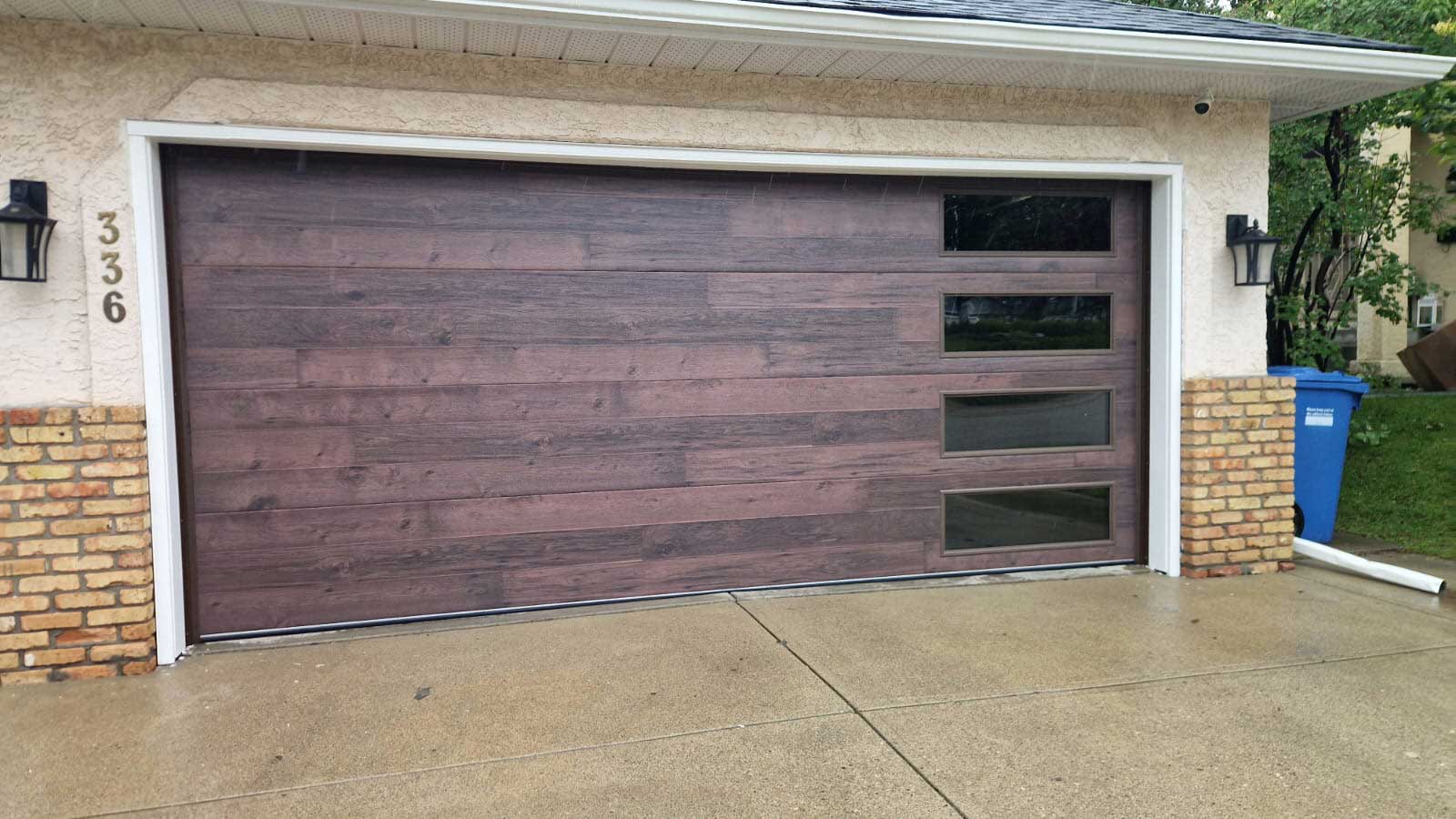 Beautiful new cocoa hickory garage door with windows